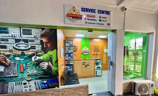 The DelsonsTech service centre on the 2nd floor of 10 Saka Tinubu Street, Victoria Island — glass frontage, service centre sign and games counter.